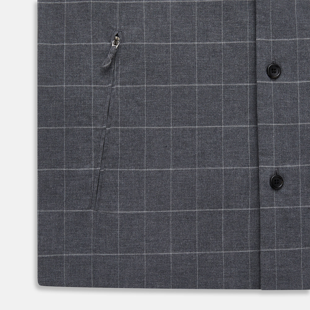 The Turnbull & Asser Charcoal Melange Check Hampstead overshirt, a long-sleeve button-up with a collar and two zippered side pockets, is laid flat on a light gray background.