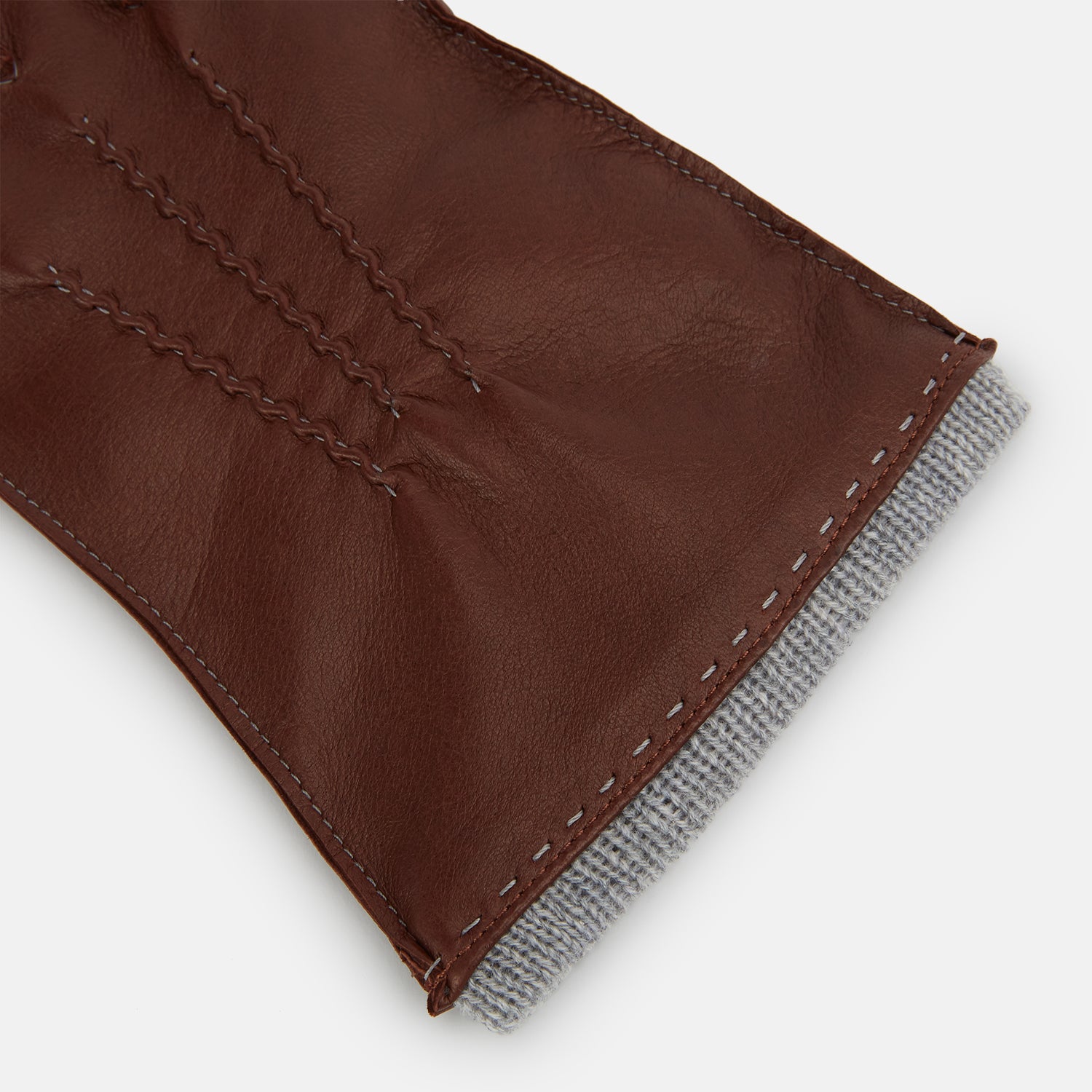 View 2 of product Turnbull & Asser's Dark Chocolate/Grey Cashmere-Lined Hairsheep Leather Gloves are shown on a white background, with one glove displaying the palm and the other the back.