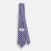 View 4 of product The Turnbull & Asser Lilac Medallion Printed Silk Tie is crafted from English silk with a geometric motif of small blue circles and a subtle checkered background.