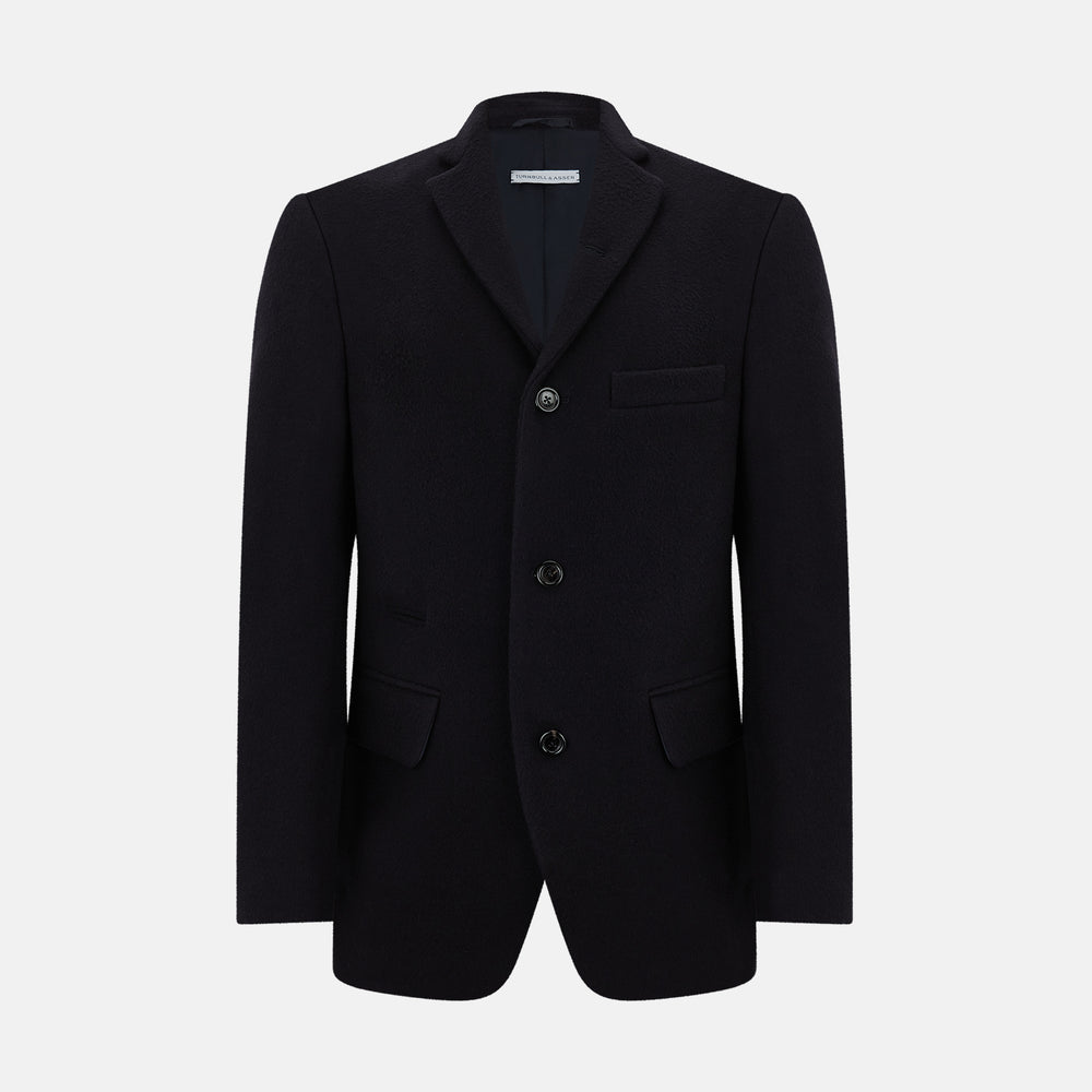 The Navy Apsley Single-Breasted Caban Coat by Turnbull & Asser features three buttons, notch lapels, a chest pocket, and two front flap pockets, shown against a plain light gray background.
