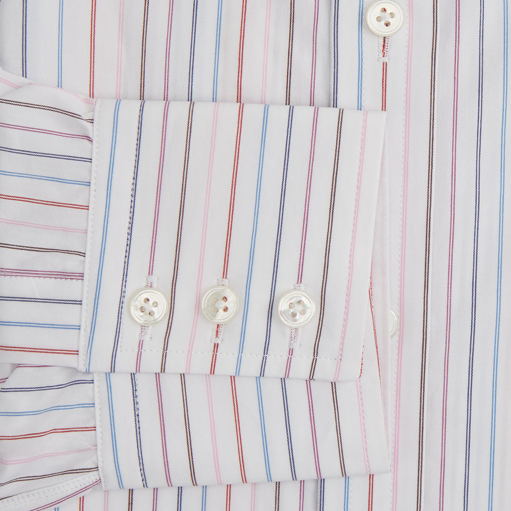 The Pink and Blue Multi Double Pinstripe Mayfair Shirt by Turnbull & Asser is a long-sleeve, button-up with a T&A collar, buttoned cuffs, and thin blue, red, and white stripes on a light background for a classic, formal look.