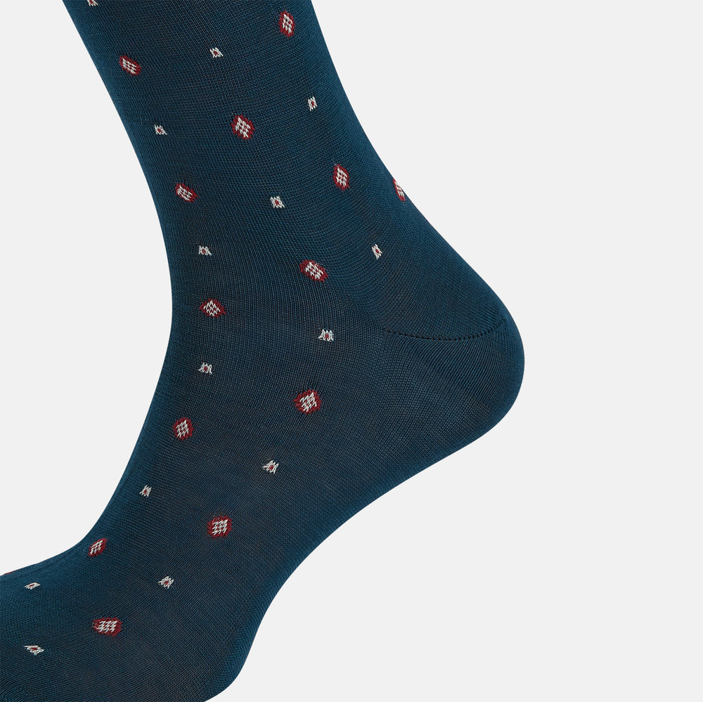 The Turnbull & Asser Azzurro Patterned Mid-Length Sock is navy blue with a ribbed cuff and features a small red and white diamond motif, shown here individually against a plain white background.