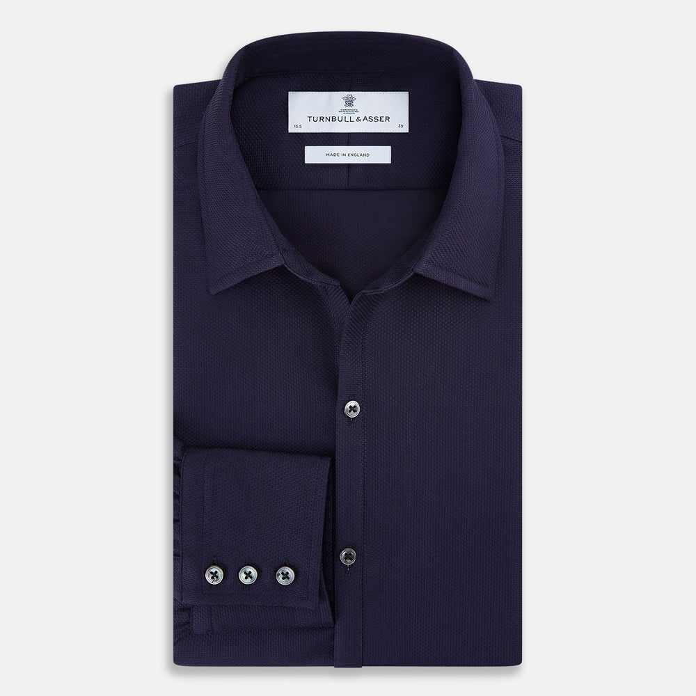 The Navy Textured Windsor Shirt by Turnbull & Asser features long sleeves, a Windsor collar, buttoned cuffs, and white buttons—a fine example of British craftsmanship—set against a plain white background.
