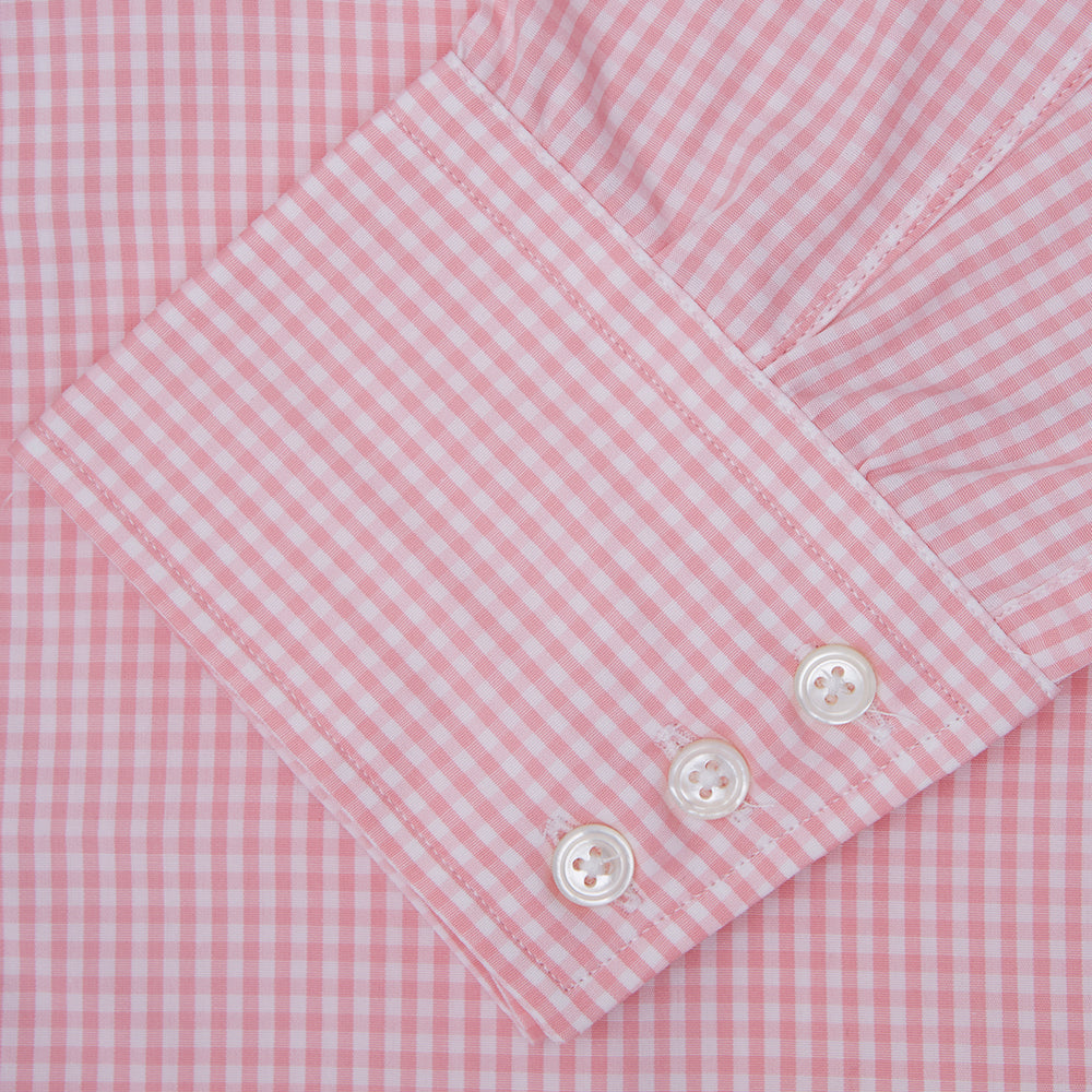 The Turnbull & Asser Light Pink Gingham Check Shirt features a classic T&A collar, 3-button cuffs, and white buttons, neatly folded on a plain white background.