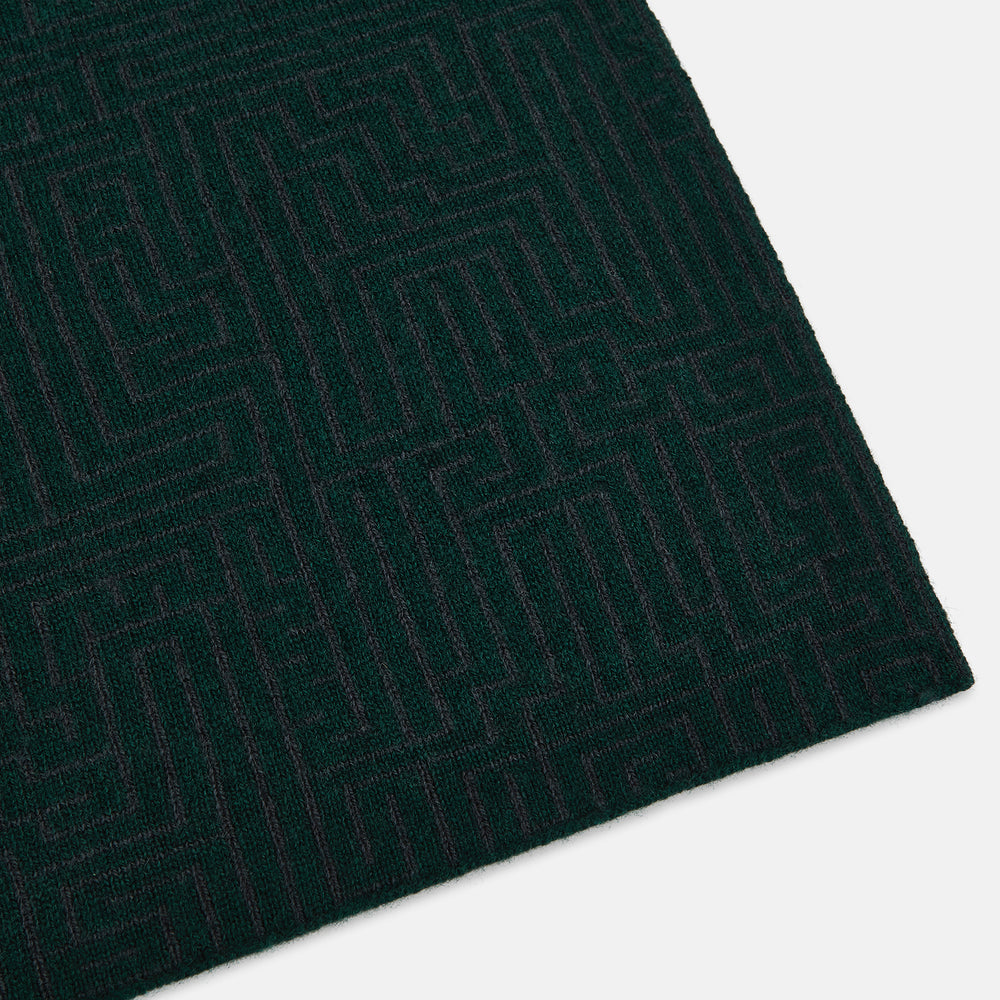 The Turnbull & Asser Forest Green and Charcoal Fretwork Cashmere Knitted Scarf, featuring a subtle geometric pattern, is neatly folded and knotted against a plain white background.