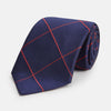 View 1 of product The Turnbull & Asser Red and Navy Window Pane Silk Tie features a refined diagonal red pattern on navy silk, making it an elegant choice for office attire.