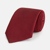 View 1 of product The HORIZONTAL TWILL BURGUNDY TIE by Turnbull & Asser features a subtle textured pattern in solid burgundy, rolled neatly and displayed against a white background—a versatile addition to any gentleman’s wardrobe.