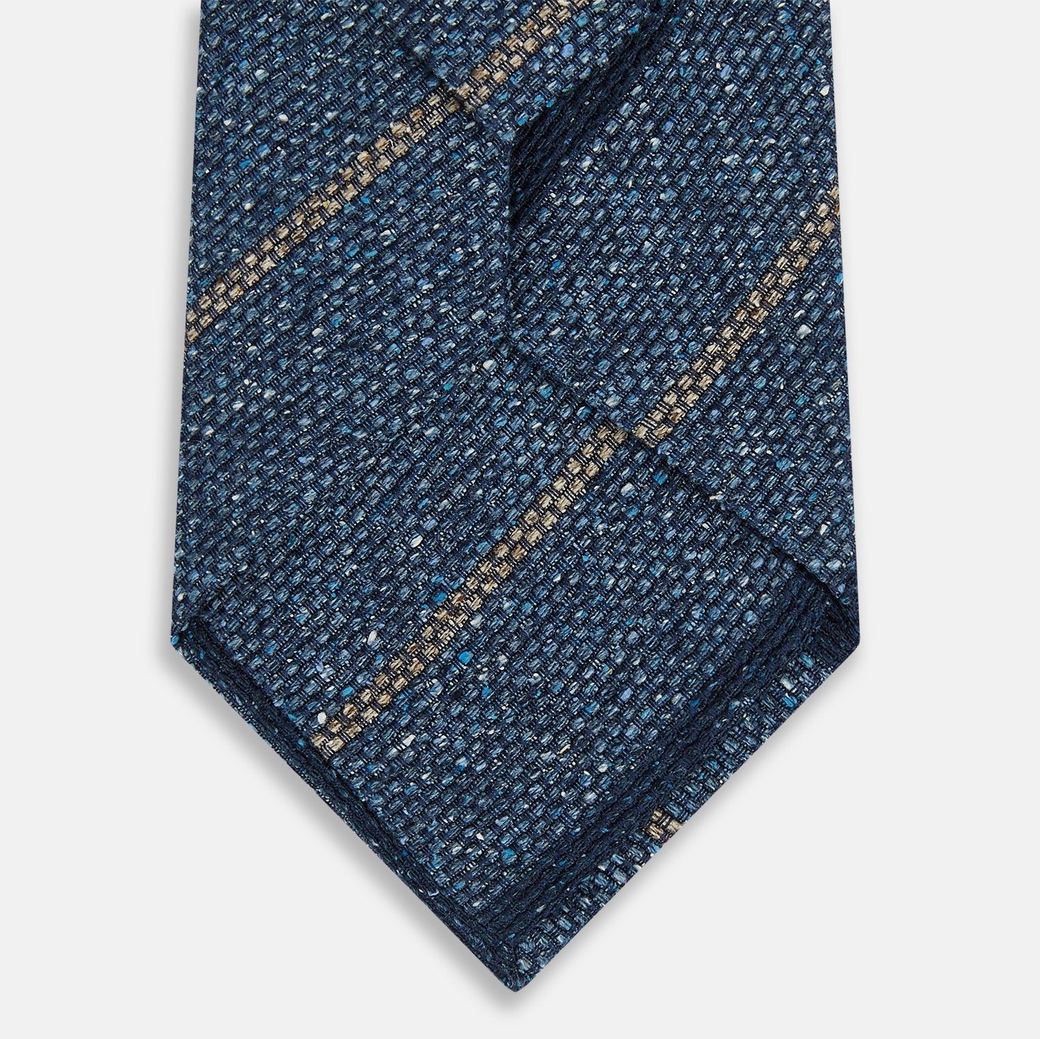 View 3 of product The Blue Multi Stripe Silk Tie by Turnbull & Asser, featuring navy and cream stripes on blue English silk, is shown rolled up against a white background.