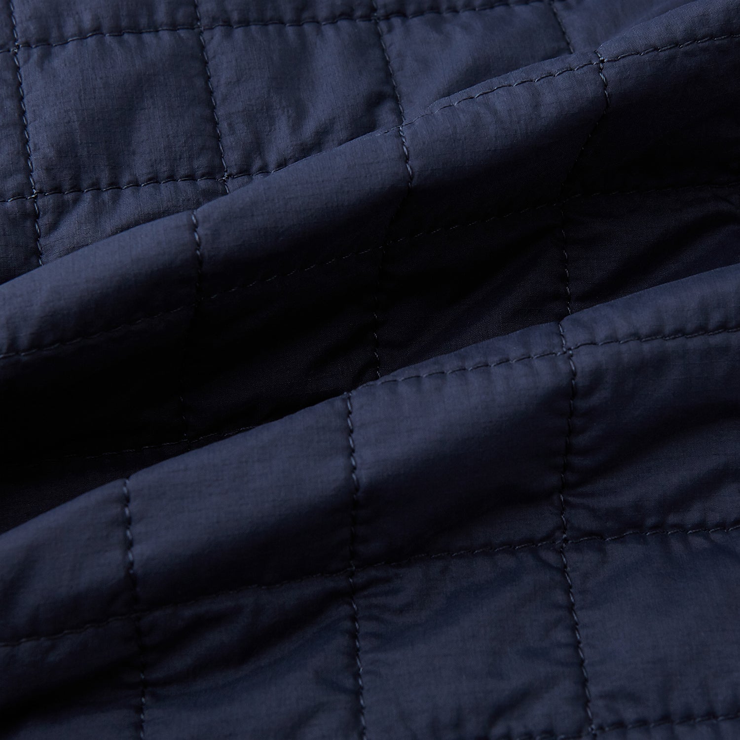 Image 4 of product The Turnbull & Asser Navy Double-Breasted Quilted Gilet is a sleeveless piece with an asymmetrical button closure, chest pocket, and two zippered side pockets, shown on a plain white background—ideal for layered dressing.