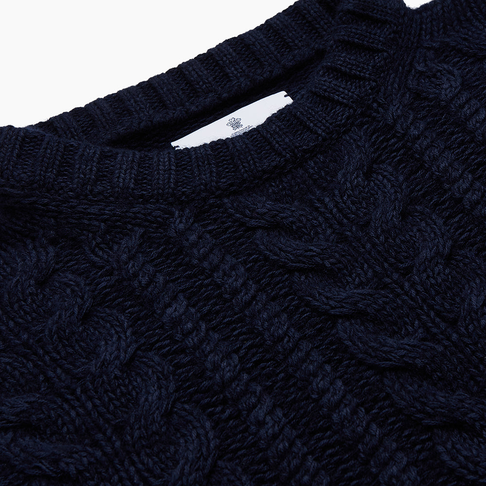 Image 2 of product The Turnbull & Asser Navy Wool and Cotton Blend Albany Guernsey Jumper, shown flat on a white background, features long sleeves, a classic cable knit pattern on the upper half, and ribbed cuffs, hem, and collar.