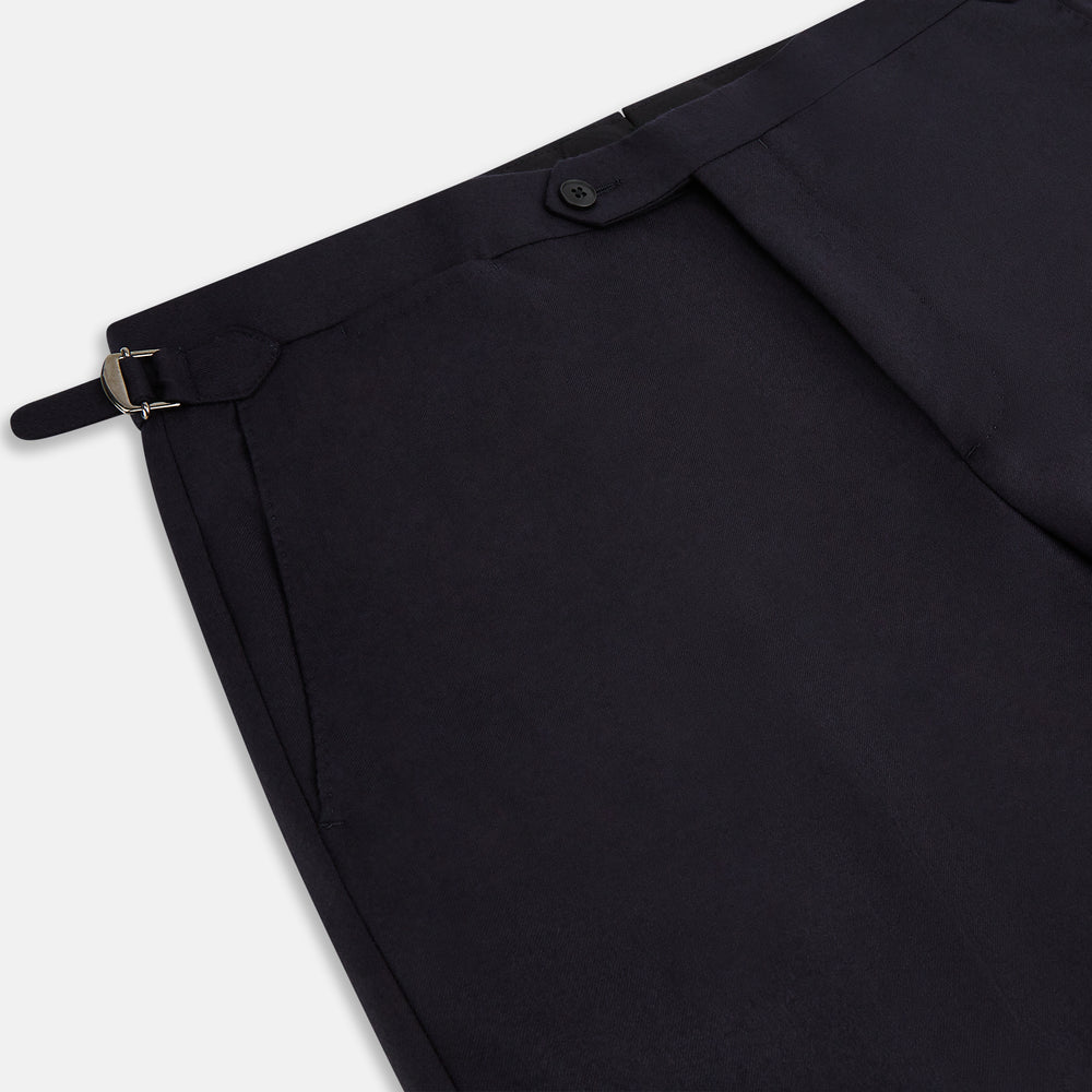 The Turnbull & Asser Long Navy Single Breasted Suit, shown on a white background, features a blazer with notch lapels and matching tailored trousers—ideal for formal occasions.