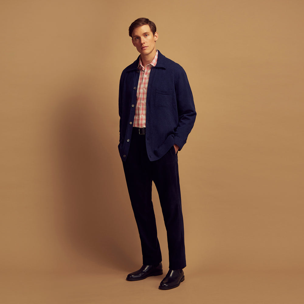 The Turnbull & Asser Navy Cashmere Duncan Knitted Shirt, a button-up with collar, long sleeves, chest pocket, and straight hem, is shown laid flat on a white background.