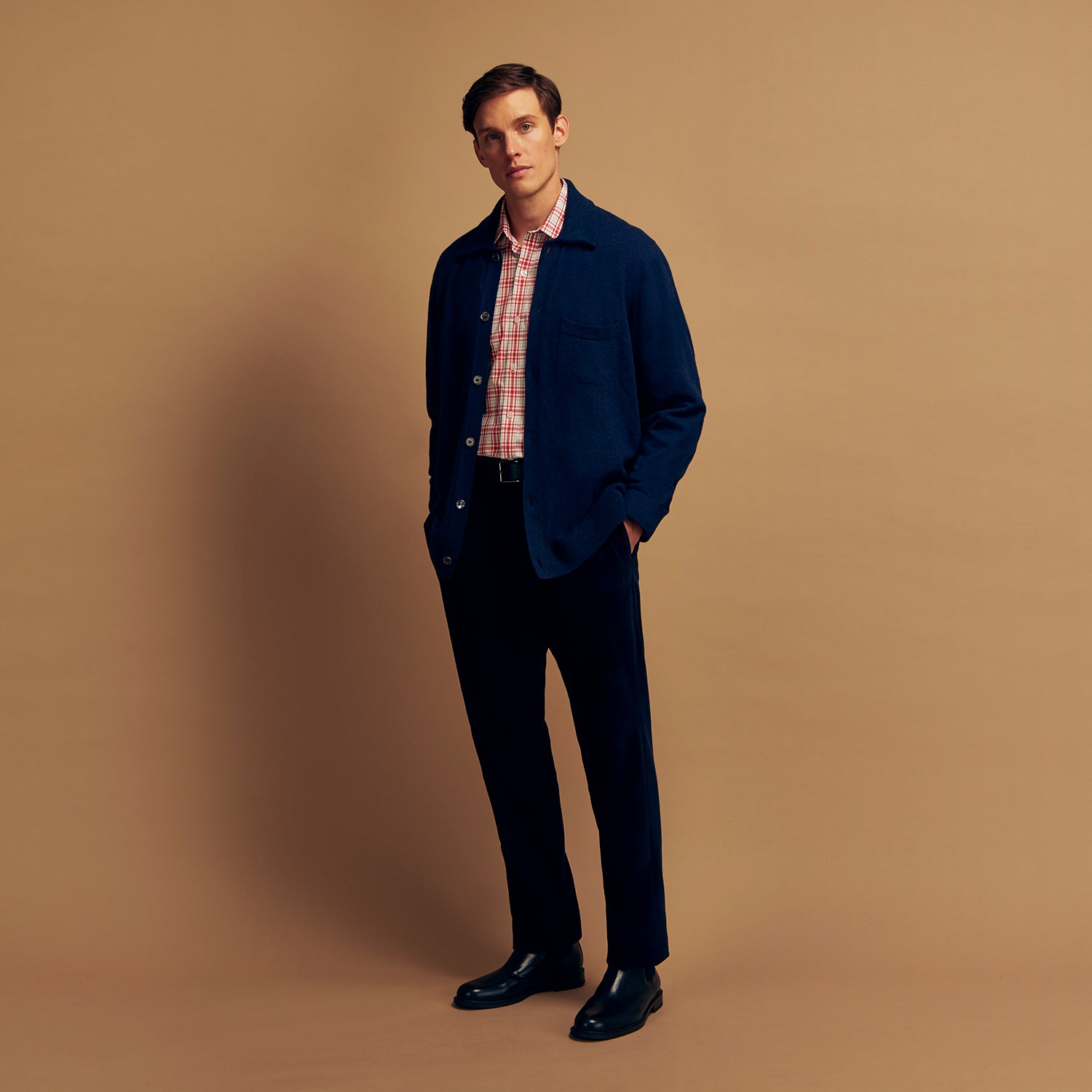 View 7 of product The Turnbull & Asser Red Check Cotton Weekend Fit Finch Shirt is a men's long-sleeved, button-up shirt with a Derby collar and red-and-white plaid pattern, displayed flat on a white background.