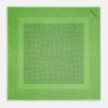 View 4 of product The Fern Green Dot Silk Pocket Square by Turnbull & Asser is crafted from pure silk, featuring a subtle black polka dot border with a denser dot pattern at the center and the brand name printed in the upper right corner.