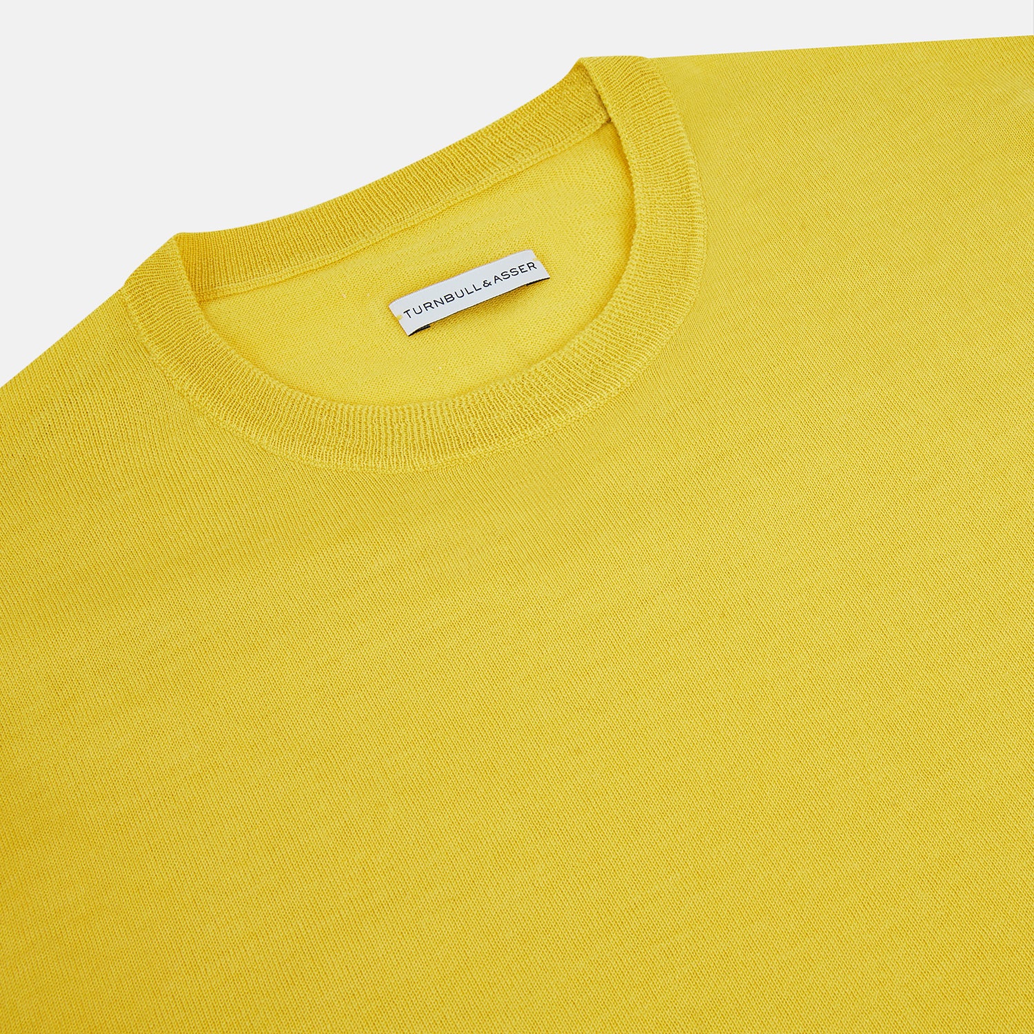 View 2 of product The Turnbull & Asser Canary Yellow Merino Round Neck Jumper features long sleeves and a crew neckline, shown here against a white background.