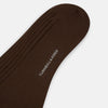 View 3 of product A single Coffee Organic Cotton Mid-Length Sock by Turnbull & Asser, featuring a ribbed texture and crafted from organic cotton, is displayed upright on a plain white background.