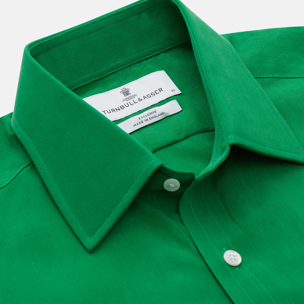 The Green Sandwashed Silk Regular Fit Mayfair Shirt by Turnbull & Asser, featuring long sleeves, a T&A collar, and white buttons, is displayed flat on a white background.