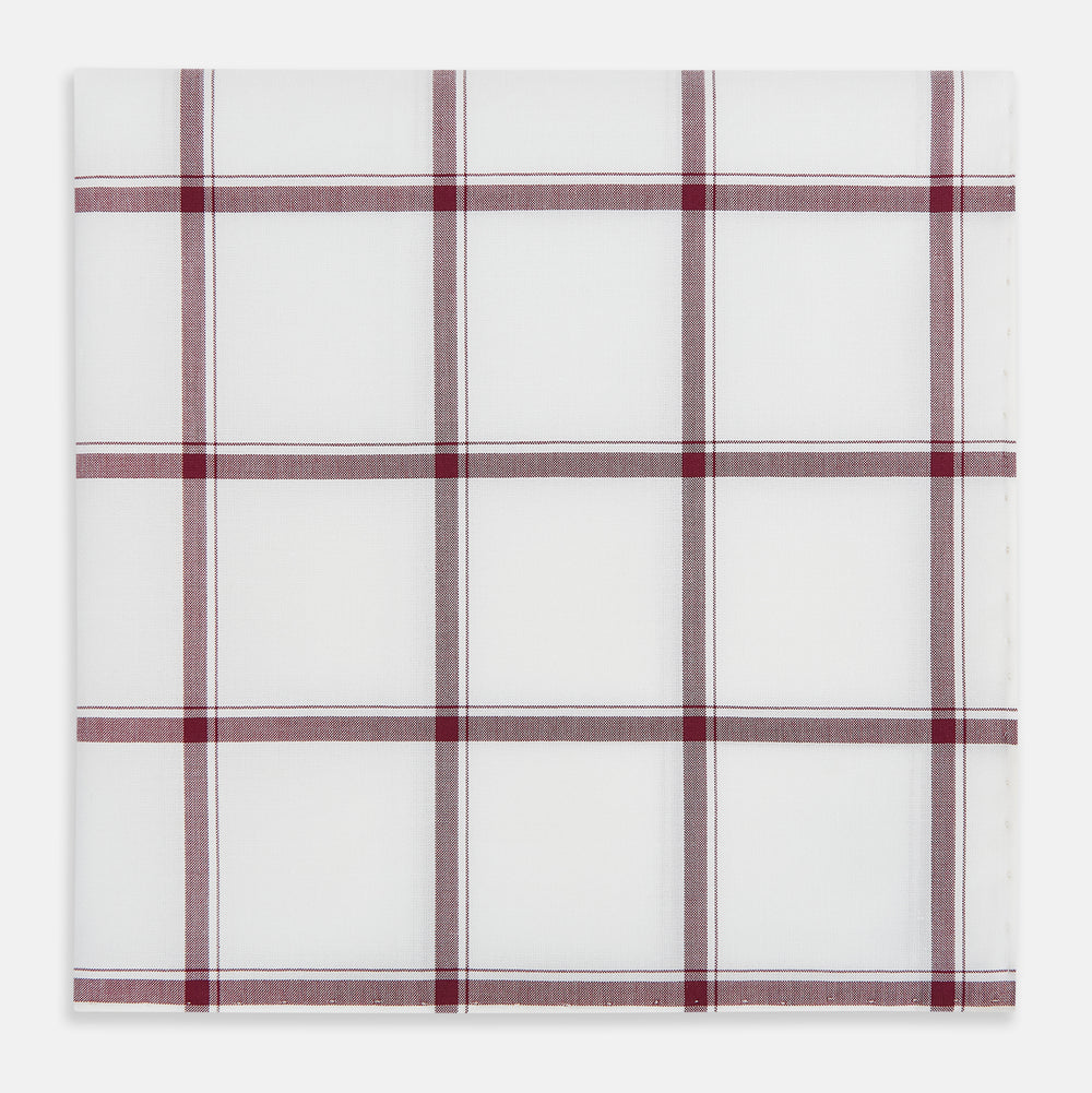 The Turnbull & Asser Burgundy Grid Check Hand-Rolled Handkerchief features a white base with burgundy grid lines forming large squares and is finished with elegant hand-rolled edges.
