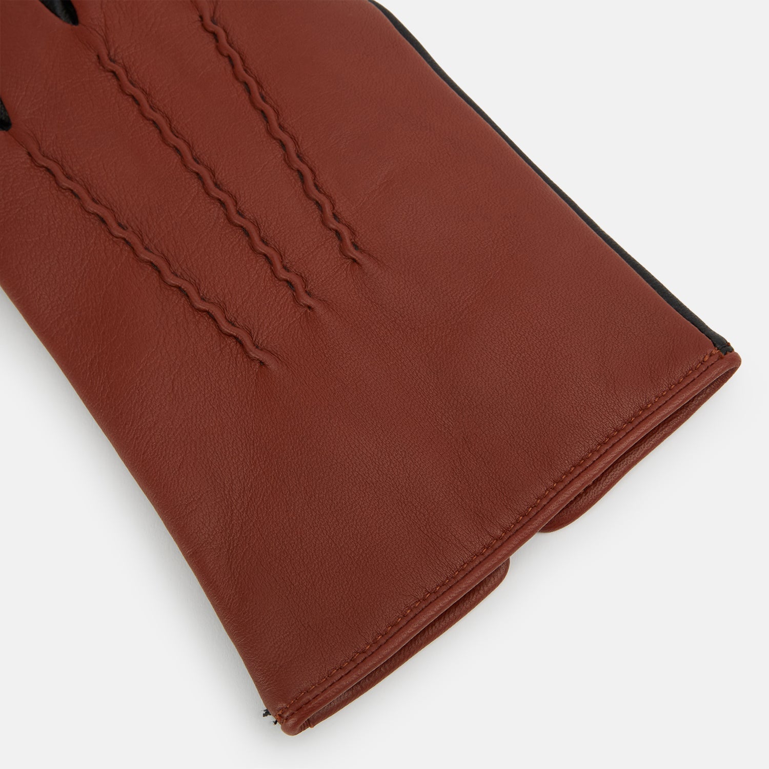 View 2 of product Turnbull & Asser Brown/Ebony Cashmere-Lined Hairsheep Leather Touchscreen Gloves are shown front and back, featuring a brown outer with subtle stitching and black palms/fingers accented with brown at the thumb and wrist.