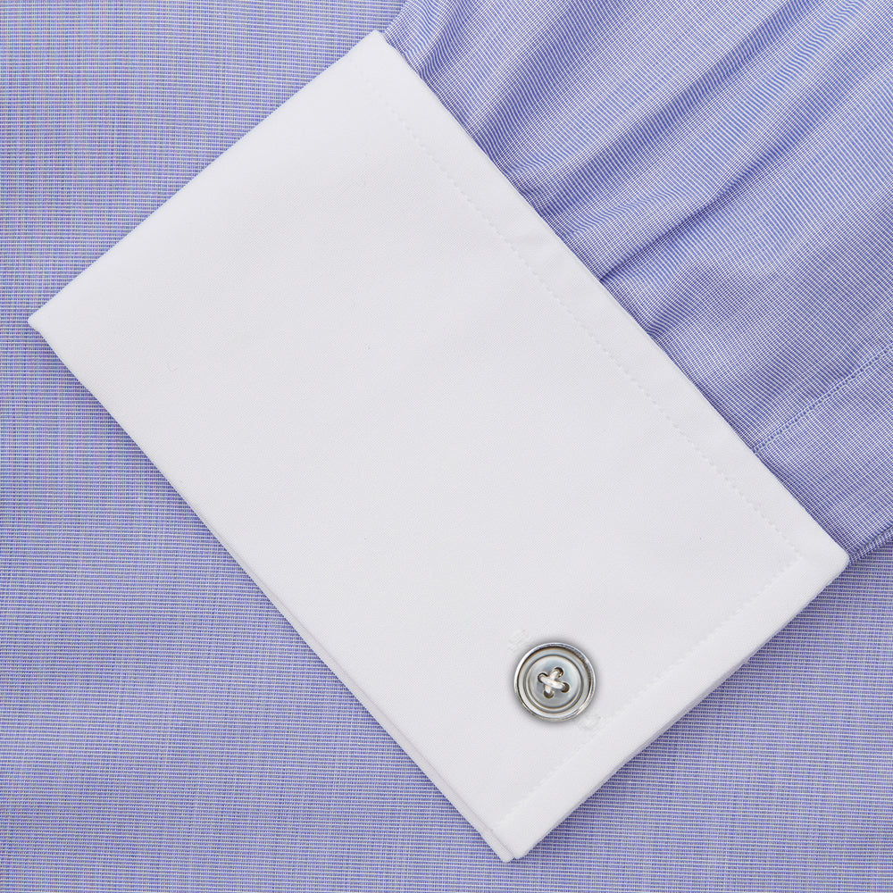 The Wall Street Shirt with White T&A Collar by Turnbull & Asser, as seen on Gordon Gekko, is folded neatly to showcase its light purple color, crisp French cuffs, and iconic contrasting collar against a plain background.
