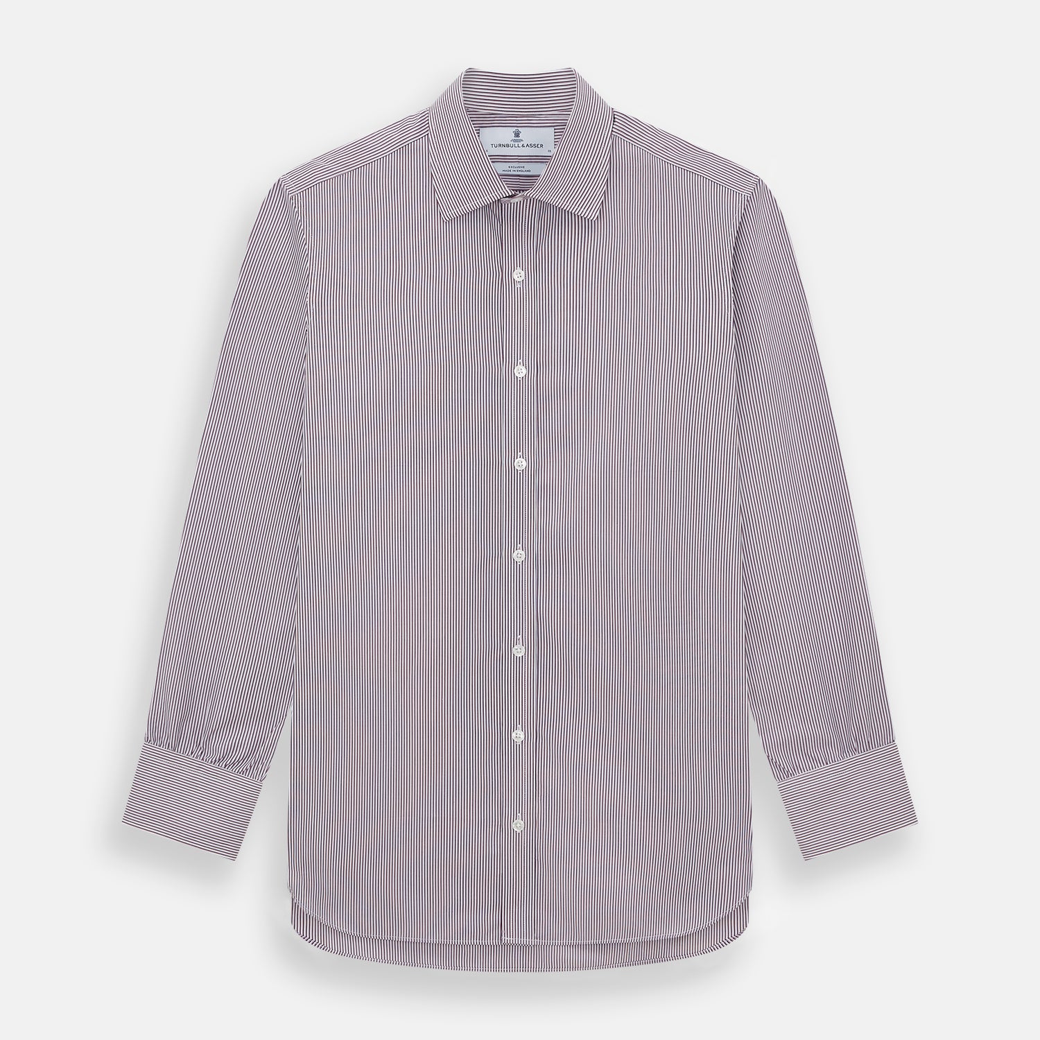 View 1 of product The Turnbull & Asser Burgundy Shadow Stripe Mayfair Shirt is a long-sleeved button-up with thin vertical burgundy stripes, classic collar, and buttoned cuffs, shown laid flat on a white background.