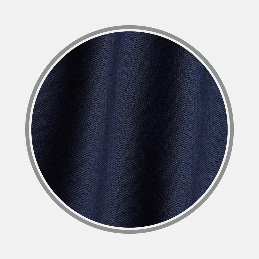 Close-up of Turnbull & Asser Plain Navy Cotton Fabric, featuring a subtle diagonal twill weave. The fabric is shown in a circular frame with a gray border on a light gray background.