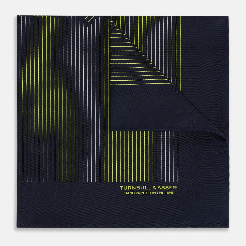 Turnbull & Asser Navy and Yellow Stripe Silk Pocket Square features hand-rolled edges, striped pattern, and "Turnbull & Asser Hand Printed in England" text in yellow on the bottom right corner.