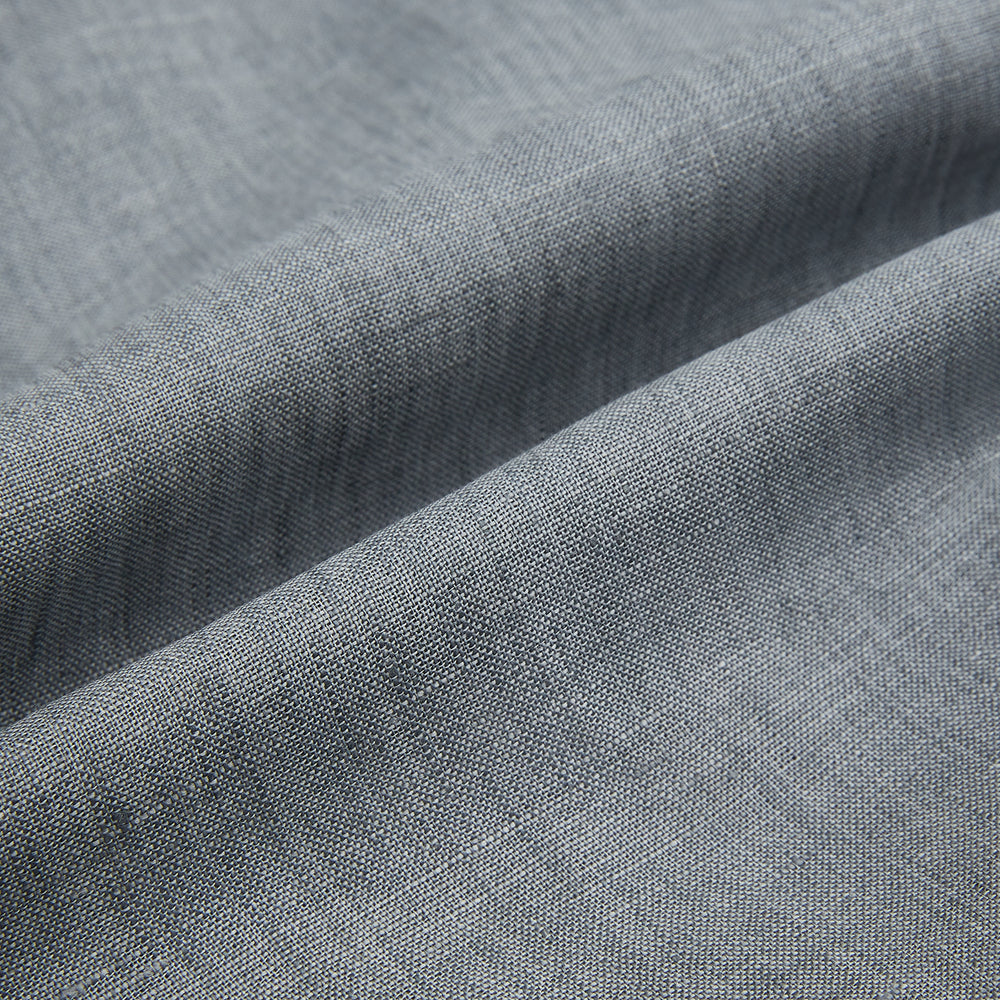 The Grey Linen Westminster Shirt by Turnbull & Asser is a long-sleeve, light gray button-up with a formal collar and white buttons, highlighting British craftsmanship and laid flat on a white background.