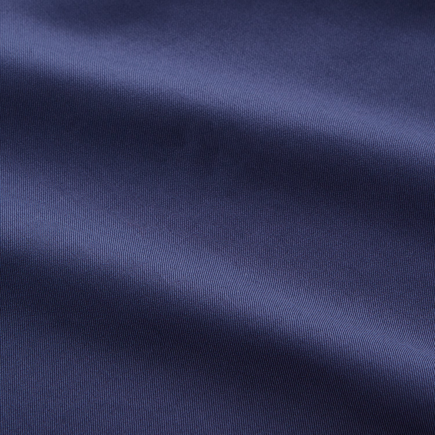 View 5 of product The Blue Piece Dyed Weekend Fit Suffolk Shirt by Turnbull & Asser features a button-down Dorset collar, chest pocket, white buttons, and long sleeves in classic navy, laid flat against a white background.