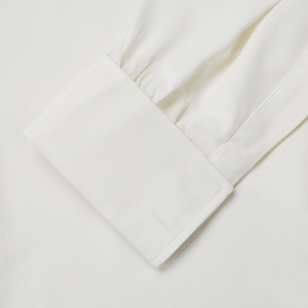 The Turnbull & Asser Cream Silk Tailored Fit Shirt is a long-sleeve button-up with a pointed collar and buttoned cuffs, displayed laid flat against a plain white background.