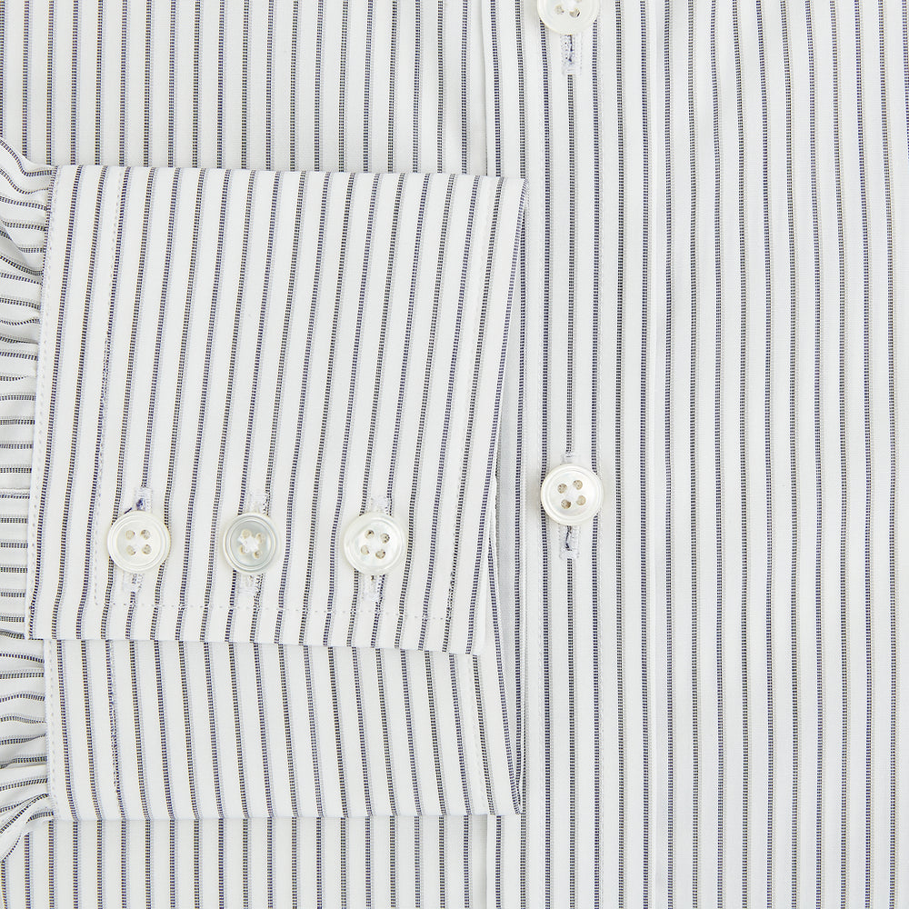 The Navy Music Stripe Mayfair Shirt by Turnbull & Asser features thin vertical blue and white stripes, a classic T&A collar, and long sleeves, shown on a plain white background.