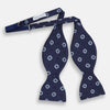 View 2 of product The Navy and Sky Blue Motif Silk Bow Tie by Turnbull & Asser features a subtle ribbed texture and light blue and white geometric floral patterns—an elegant choice for formalwear.