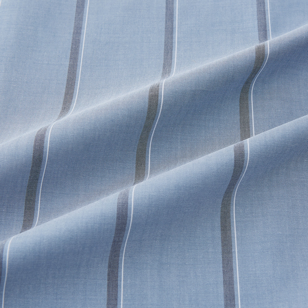 The Steel Blue Track Stripe Westminster Shirt by Turnbull & Asser features dark pinstripes, a classic collar, white buttons, and buttoned cuffs—expertly crafted to highlight British craftsmanship. Laid flat on white background.