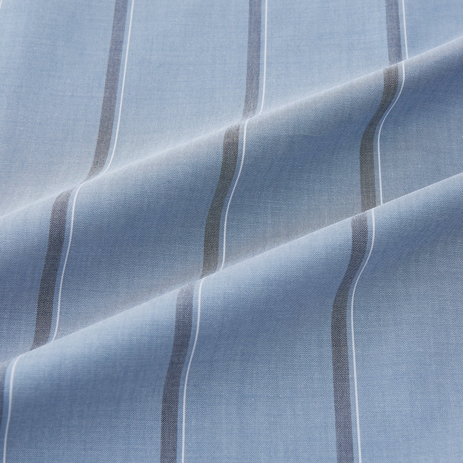 View 8 of product The Steel Blue Track Stripe Westminster Shirt by Turnbull & Asser features dark pinstripes, a classic collar, white buttons, and buttoned cuffs—expertly crafted to highlight British craftsmanship. Laid flat on white background.