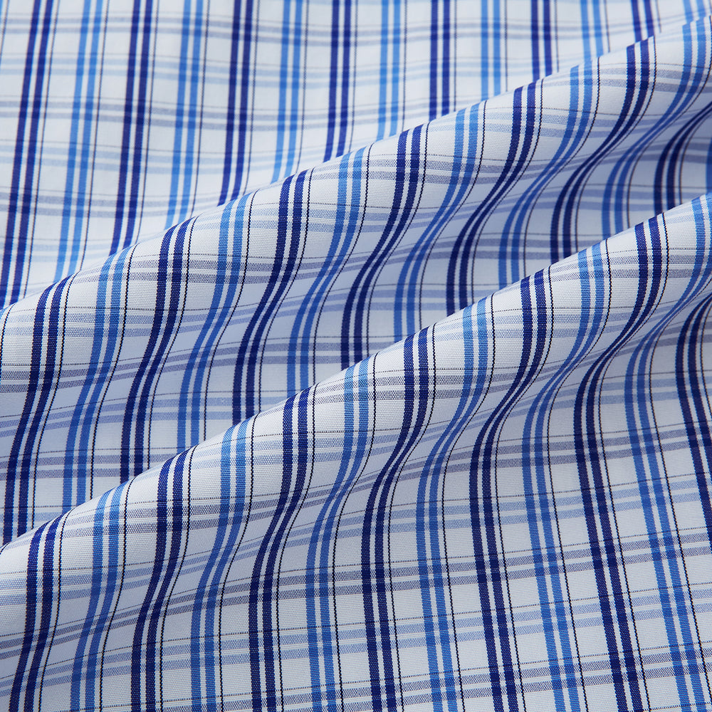 Turnbull & Asser's Blue and Navy Multi Check Piccadilly Shirt features long sleeves, a pointed collar, and two buttoned chest pockets, shown on a white background.