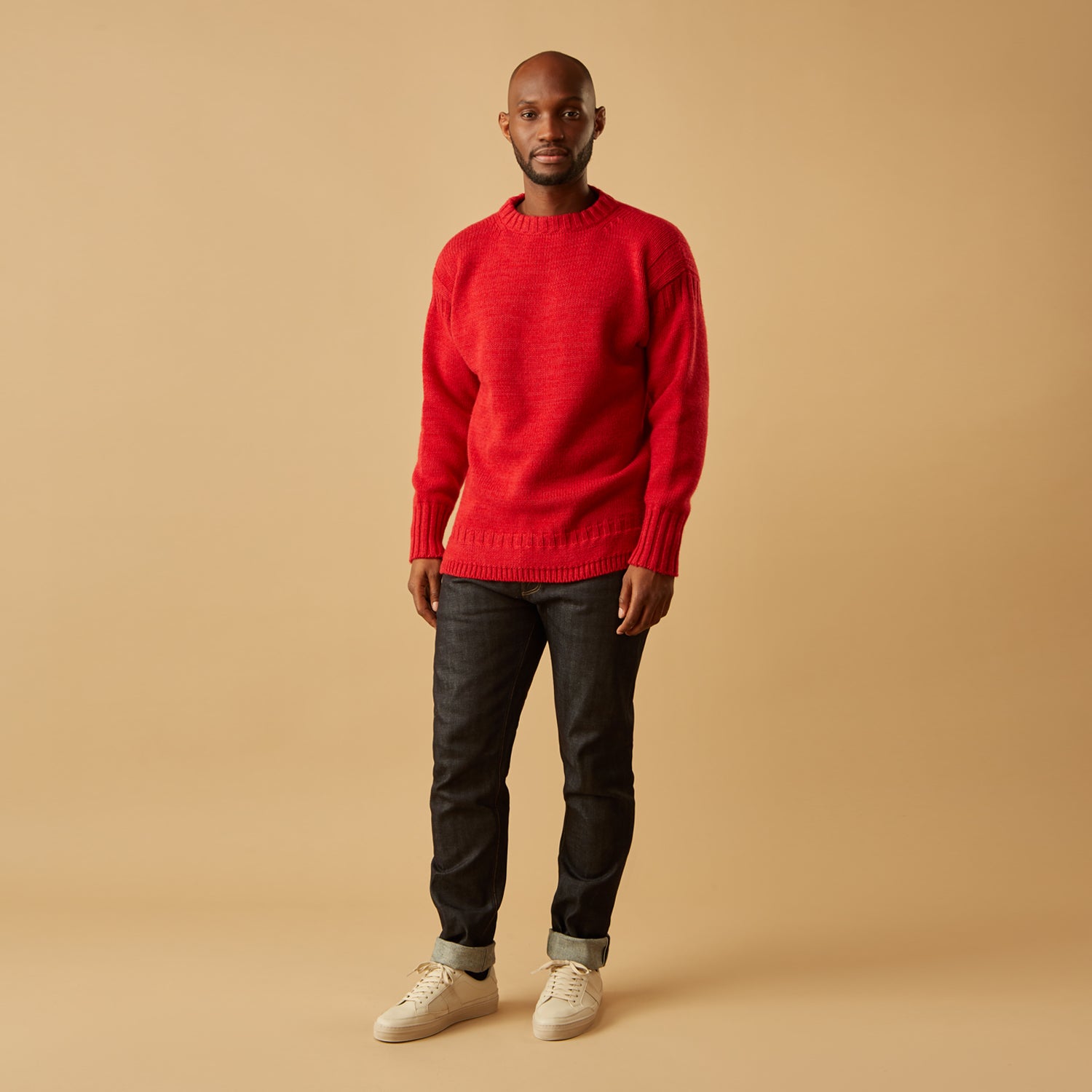 View 2 of product The Red Lewis Guernsey Knitted Jumper by Turnbull & Asser is a bright red wool-cotton, long-sleeve jumper with a round neckline, ribbed cuffs, and ribbed hem, shown against a white background.