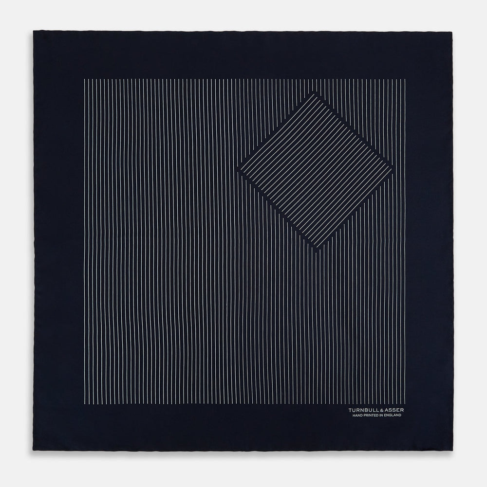 A Navy and Grey Stripe Silk Pocket Square by Turnbull & Asser, featuring hand-rolled edges and brand text in the corner. One corner is folded to show the reverse side.