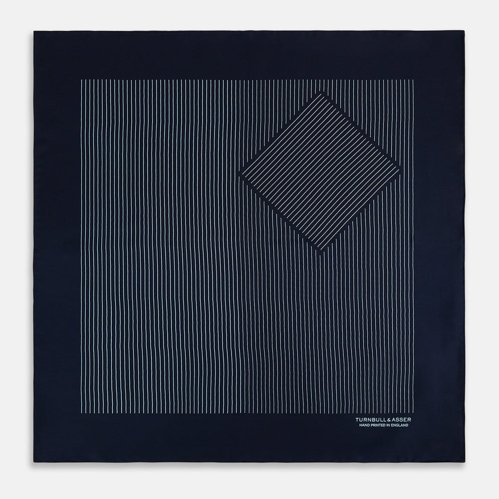 The Turnbull & Asser Navy and Light Blue Stripe Silk Pocket Square features hand-rolled edges and "Turnbull & Asser Hand Printed in England" in white text.