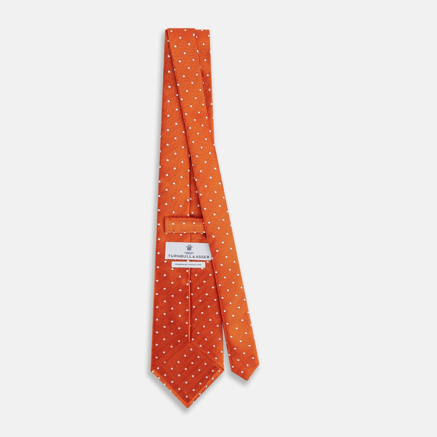 View 4 of product The Turnbull & Asser Orange and White Micro Dot Silk Tie features a subtle herringbone weave with small white dots—an elegant, modern accessory for the office.