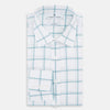 View 5 of product The Turnbull & Asser Sage Grid Check Mayfair Shirt is a white, long-sleeve shirt made from Italian cotton with a light blue and sage grid pattern, shown neatly laid flat on a plain, light background.