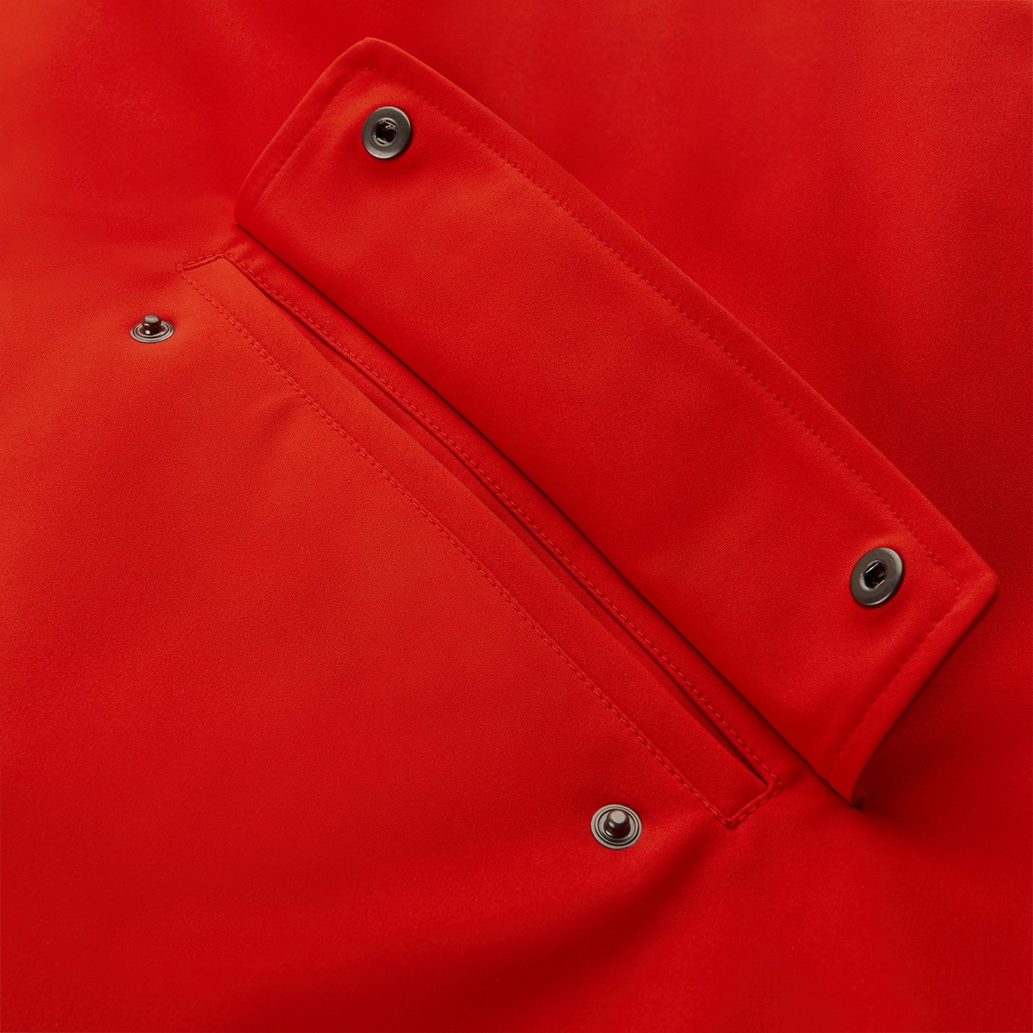 View 8 of product Wearing the Turnbull & Asser Red Walter Sealup Parka with Detachable Liner, black pants, and white sneakers, a person stands in profile against a plain light background—perfect for travel.