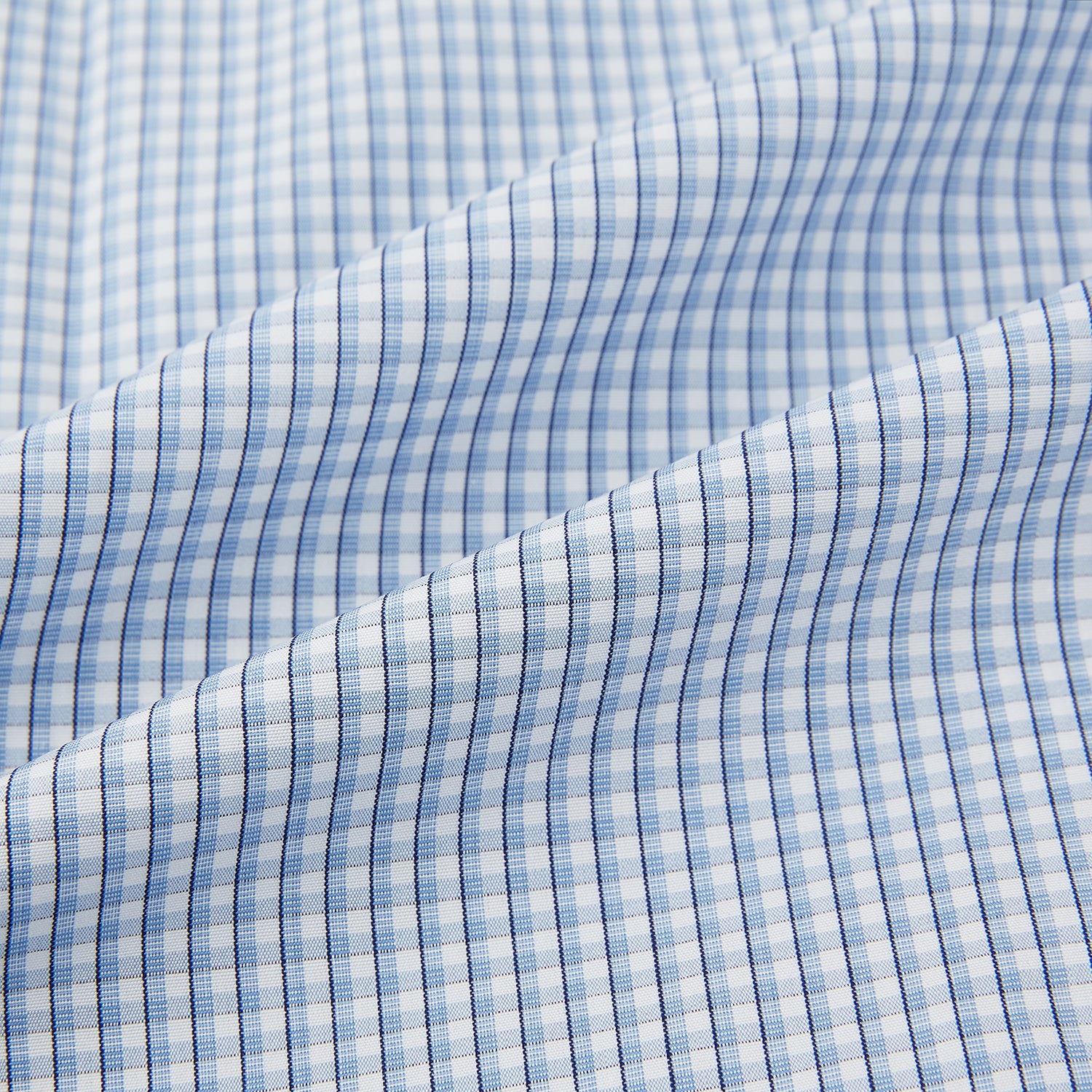 View 6 of product The Turnbull & Asser Blue Micro Shadow Check Mayfair Shirt features a long-sleeve, button-up design with a small blue and white check pattern, pointed T&A collar, and classic cuffs.