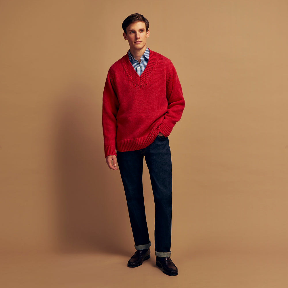 The Turnbull & Asser Raspberry Red Cashmere Edwards V-Neck Sweater features long sleeves, ribbed cuffs and hem, and is shown laid flat on a white background.