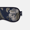 View 3 of product The Turnbull & Asser Navy Bloomsbury Jacquard Cashmere Lined Sleep Mask and Bag features a dark blue backdrop with beige, olive green, and gray floral patterns, plus elastic straps for comfort.