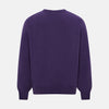 View 3 of product The Turnbull & Asser Purple Cashmere Round Neck Jumper features long sleeves, ribbed cuffs, hem, and collar for an elegant silhouette. This versatile knitwear piece is shown against a white background.