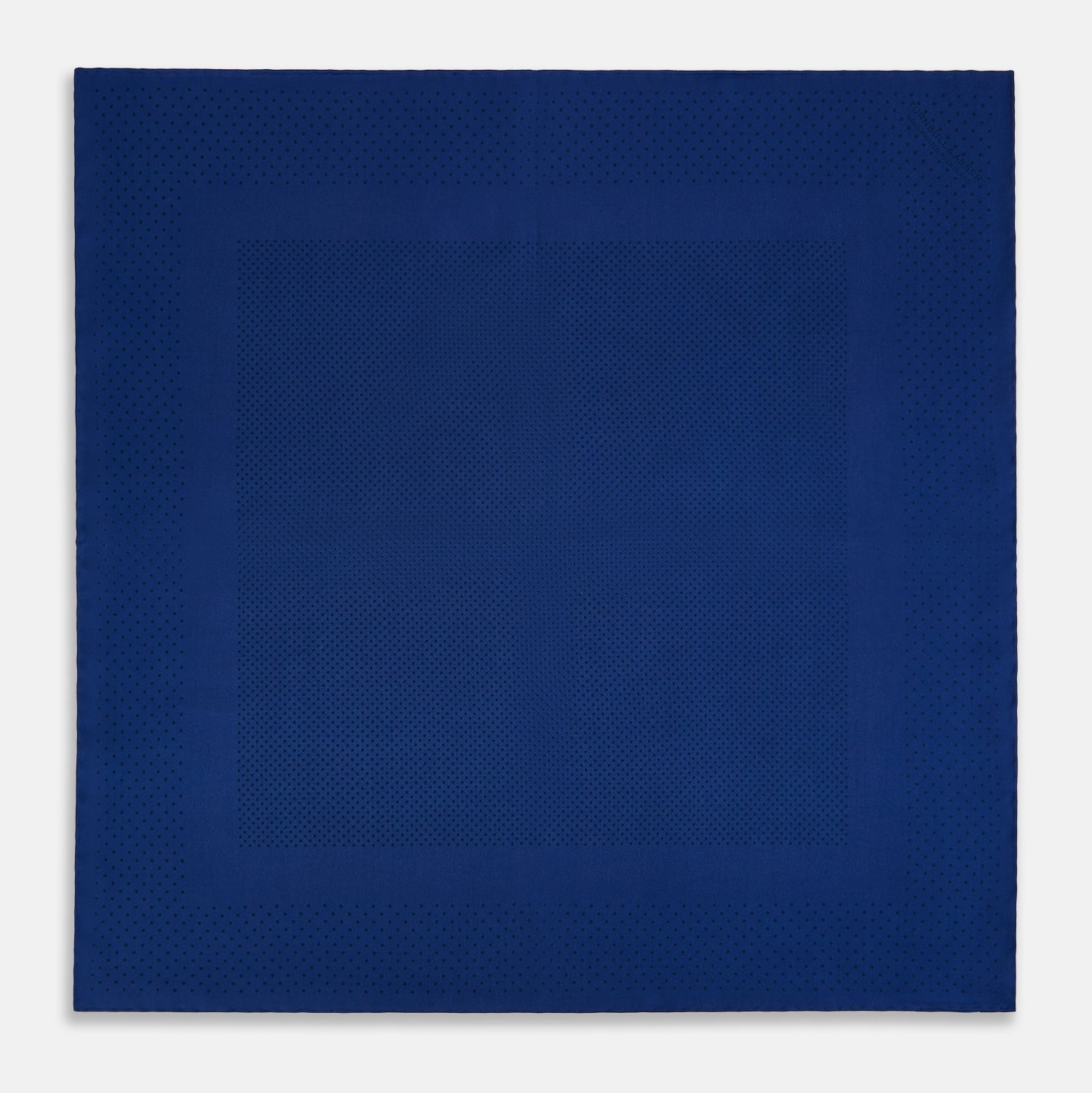 View 4 of product The Turnbull & Asser Navy Dot Silk Pocket Square, folded with neat hand-rolled edges, features a subtle navy polka dot pattern on dark blue silk and is shown against a white background.