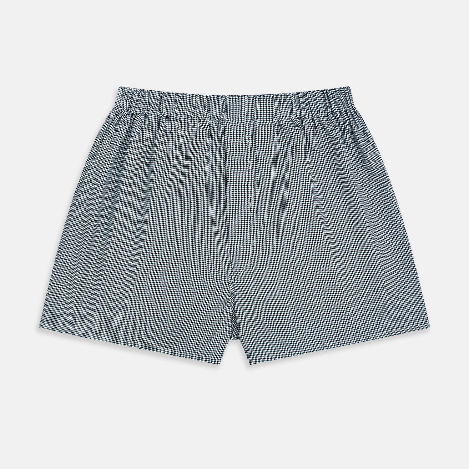 View 1 of product Turnbull & Asser Green Houndstooth Godfrey Boxer Shorts with an elastic waistband, showcasing a small black and white houndstooth pattern, are laid flat on a white background.