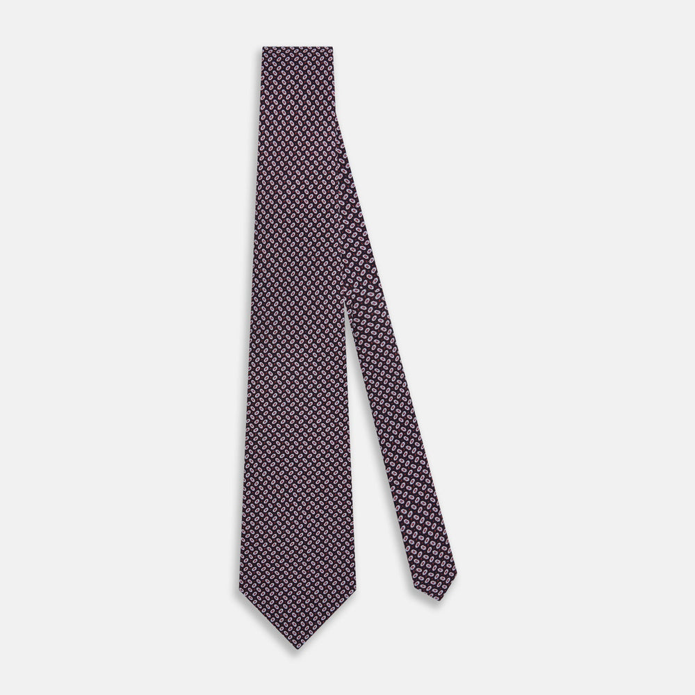 The Turnbull & Asser Red and Navy Oval-Patterned Silk Tie features a refined oval motif on navy silk, ideal for formal wear, and is showcased on a plain white background.