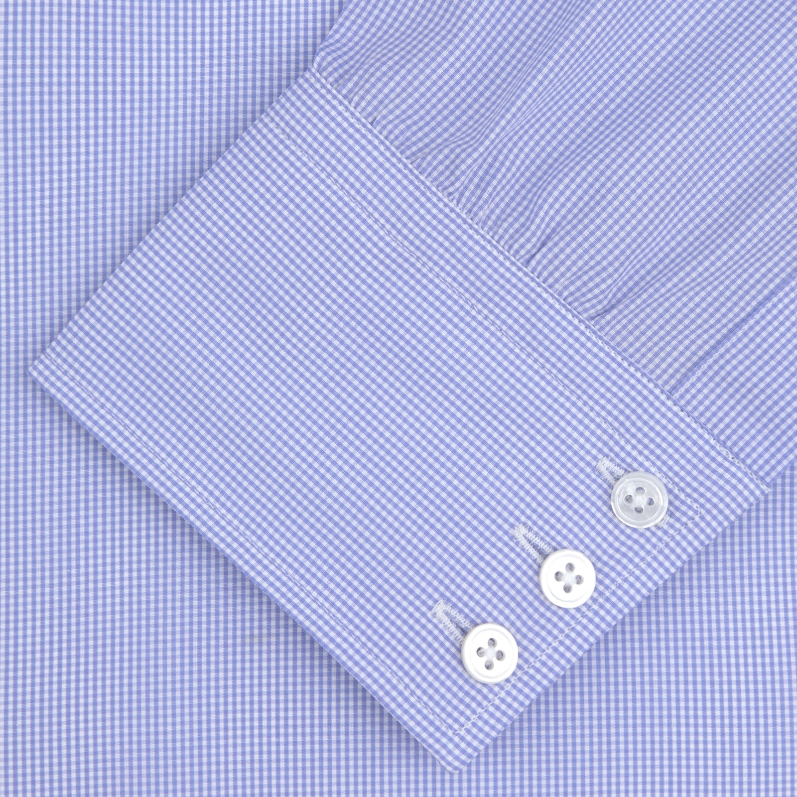 Image 2 of product Turnbull & Asser's Blue Fine Check Sea Island Quality Cotton Shirt features a T&A collar, 3-button cuffs, and white buttons, all neatly folded and displayed on a plain white background.