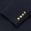 View 4 of product The Short Navy Single Breasted Classic Blazer by Turnbull & Asser features two gold buttons, notched lapels, and three front pockets, shown here on a plain white background.